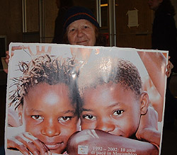 Janet holding a poster commemorating the peace agreement in Mozambique